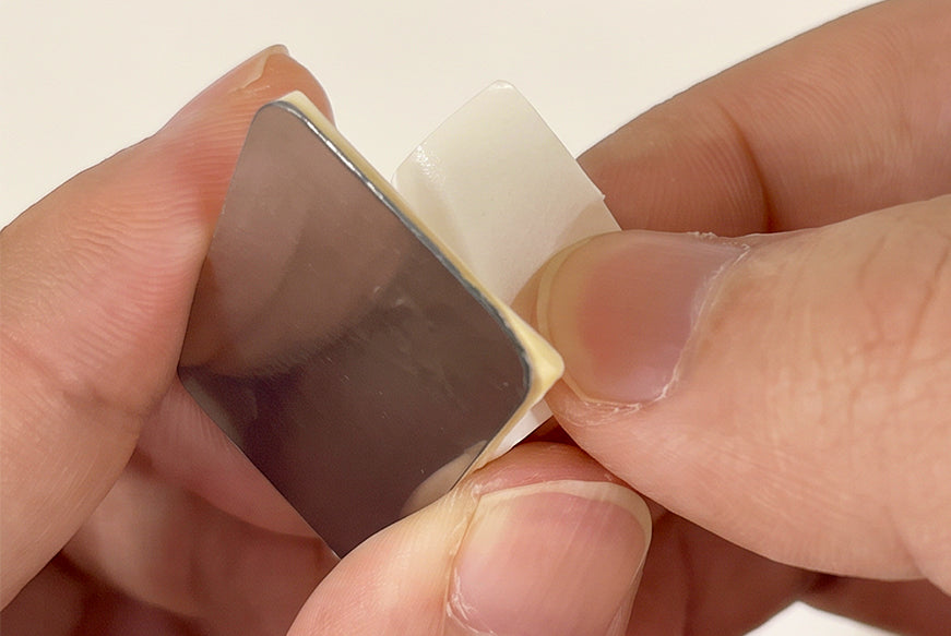 Peel the adhesive backing from the mounting plate